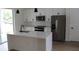 Modern kitchen with stainless steel appliances, white cabinets, and a large center island at 2438 Sw 165Th Street Rd, Ocala, FL 34473