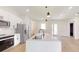 This modern kitchen offers stainless appliances, white cabinets, and an island perfect for meal preparation at 2438 Sw 165Th Street Rd, Ocala, FL 34473