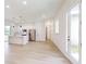 Open-concept living space with bright kitchen, stainless steel appliances, and a view of the hallway at 2438 Sw 165Th Street Rd, Ocala, FL 34473