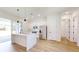 Open kitchen featuring modern appliances, white cabinetry, and a center island with seating at 2438 Sw 165Th Street Rd, Ocala, FL 34473