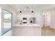 Bright kitchen with white cabinets, modern appliances, and a central island with pendant lighting at 2438 Sw 165Th Street Rd, Ocala, FL 34473