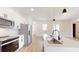 Modern kitchen features stainless appliances, sleek white cabinets, and an island with a stainless sink at 2438 Sw 165Th Street Rd, Ocala, FL 34473