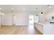 Bright living room with light wood floors and sliding glass doors to the backyard at 2438 Sw 165Th Street Rd, Ocala, FL 34473