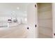 View of an open pantry with white wire shelving, with an open concept kitchen in the background at 2438 Sw 165Th Street Rd, Ocala, FL 34473