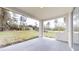 View of a covered patio overlooking the green backyard at 2438 Sw 165Th Street Rd, Ocala, FL 34473