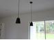 Stylish black pendant lights hang above kitchen island, adding modern touch at 2438 Sw 165Th Street Rd, Ocala, FL 34473