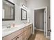 Bright bathroom featuring a double sink vanity, decorative mirrors, and an adjacent toilet room at 2540 Ne 120Th St, Anthony, FL 32617