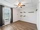 Bright bedroom has a ceiling fan, window with curtains, and wood-look floors at 2540 Ne 120Th St, Anthony, FL 32617