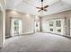 Spacious bedroom featuring carpet, ceiling fan, recessed lighting, and large windows with view at 2540 Ne 120Th St, Anthony, FL 32617