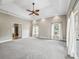 Spacious bedroom featuring carpet, tray ceiling, and large windows for ample natural light at 2540 Ne 120Th St, Anthony, FL 32617
