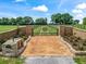 Elegant gated entrance with brick columns, landscaping, and a custom gate leading to the property at 2540 Ne 120Th St, Anthony, FL 32617