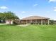 Beautiful home featuring a long covered porch, lush lawn, and mature landscaping with a detached garage at 2540 Ne 120Th St, Anthony, FL 32617