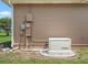 Tan house showcasing a Generac backup generator with utility connections at 2540 Ne 120Th St, Anthony, FL 32617