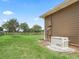 Tan house showcasing a Generac backup generator and green lawn at 2540 Ne 120Th St, Anthony, FL 32617
