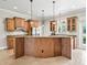 Kitchen with granite countertops, wooden cabinets, stainless appliances and an island at 2540 Ne 120Th St, Anthony, FL 32617