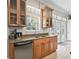 Kitchen area with stainless dishwasher and sink, dark cabinets, granite counter tops, and double doors at 2540 Ne 120Th St, Anthony, FL 32617