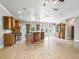Expansive kitchen featuring wood cabinetry, a large island, stainless appliances, and an open layout at 2540 Ne 120Th St, Anthony, FL 32617