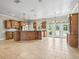 Spacious kitchen boasts a large island, wood cabinets, granite countertops, and stainless steel appliances at 2540 Ne 120Th St, Anthony, FL 32617