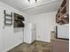 Compact kitchenette includes a refrigerator, shelving, and laminate flooring at 2540 Ne 120Th St, Anthony, FL 32617