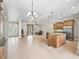 Open-concept living room showcases tile flooring, elegant lighting, and a seamless flow into the kitchen area at 2540 Ne 120Th St, Anthony, FL 32617