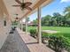 Extended covered porch with stamped concrete flooring showcasing the lush backyard and surrounding landscape at 2540 Ne 120Th St, Anthony, FL 32617