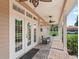 Spacious covered porch with ceiling fans and outdoor seating overlooking the expansive backyard at 2540 Ne 120Th St, Anthony, FL 32617