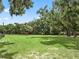 Picture of a large grassy yard with a shade structure and mature trees at 2540 Ne 120Th St, Anthony, FL 32617