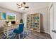Home office with built-in shelves, a well-lit desk, and a large window overlooking the yard at 37 Water Track Dr, Ocala, FL 34472