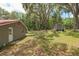 Spacious backyard featuring a shed, mature trees, and partially fenced in yard at 4010 Sw 7Th Avenue Rd, Ocala, FL 34471