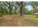 Large backyard featuring mature trees and a shed at 4010 Sw 7Th Avenue Rd, Ocala, FL 34471