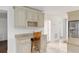 Kitchen bar includes custom cabinets, granite countertops, an area for barstool seating, and a wine rack at 4010 Sw 7Th Avenue Rd, Ocala, FL 34471