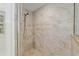 Tiled shower featuring neutral colored tiles and shower head at 4010 Sw 7Th Avenue Rd, Ocala, FL 34471