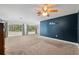 Spacious bedroom with neutral carpet, blue accent wall and lots of natural light at 4010 Sw 7Th Avenue Rd, Ocala, FL 34471