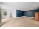 Spacious bedroom features plush carpet, a ceiling fan and a calming blue accent wall at 4010 Sw 7Th Avenue Rd, Ocala, FL 34471