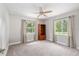 Bedroom with neutral carpet and ceiling fan, plus two windows that let in plenty of natural light at 4010 Sw 7Th Avenue Rd, Ocala, FL 34471