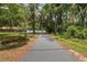 Long paved driveway leads to a ranch-style home in a serene, wooded setting at 4010 Sw 7Th Avenue Rd, Ocala, FL 34471