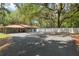 Spacious driveway and landscaping highlights this ranch-style home with red metal roof at 4010 Sw 7Th Avenue Rd, Ocala, FL 34471