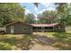 Exterior view of home with red roof, white trim, and expansive backyard at 4010 Sw 7Th Avenue Rd, Ocala, FL 34471
