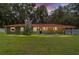 Charming home exterior with a well-manicured lawn, covered porch, and classic architectural details at 4010 Sw 7Th Avenue Rd, Ocala, FL 34471