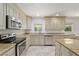 Modern kitchen features stainless steel appliances, tile floors, granite countertops and ample cabinet space at 4010 Sw 7Th Avenue Rd, Ocala, FL 34471