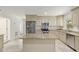 Large kitchen featuring custom cabinets, stone countertops, stainless steel appliances, and center island at 4010 Sw 7Th Avenue Rd, Ocala, FL 34471