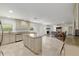 Open-concept kitchen with an island, stainless steel appliances, granite countertops and views to the living room at 4010 Sw 7Th Avenue Rd, Ocala, FL 34471