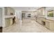 Beautiful kitchen with custom cabinets, stone countertops, stainless steel appliances, and tile floors at 4010 Sw 7Th Avenue Rd, Ocala, FL 34471