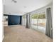 Bright living room features large sliding glass doors and neutral carpeting at 4010 Sw 7Th Avenue Rd, Ocala, FL 34471