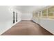 Bright sunroom with brown carpet and white brick walls, with doors to outside at 4010 Sw 7Th Avenue Rd, Ocala, FL 34471