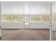 Bright sunroom with brown carpet and white brick walls and access to backyard at 4010 Sw 7Th Avenue Rd, Ocala, FL 34471