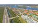 Overhead view of waterfront neighborhood with residences, marina, and lush greenery along the waterway at 420 Bouchelle Dr # 204, New Smyrna Beach, FL 32169