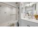 Modern bathroom featuring a glass shower door, bright vanity, and wood look floors at 420 Bouchelle Dr # 204, New Smyrna Beach, FL 32169