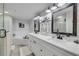 Bright bathroom featuring double vanity with white marble counters and modern black fixtures at 420 Bouchelle Dr # 204, New Smyrna Beach, FL 32169