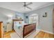Cozy bedroom featuring a wood bed frame, hardwood floors, and a window with white shutters at 420 Bouchelle Dr # 204, New Smyrna Beach, FL 32169